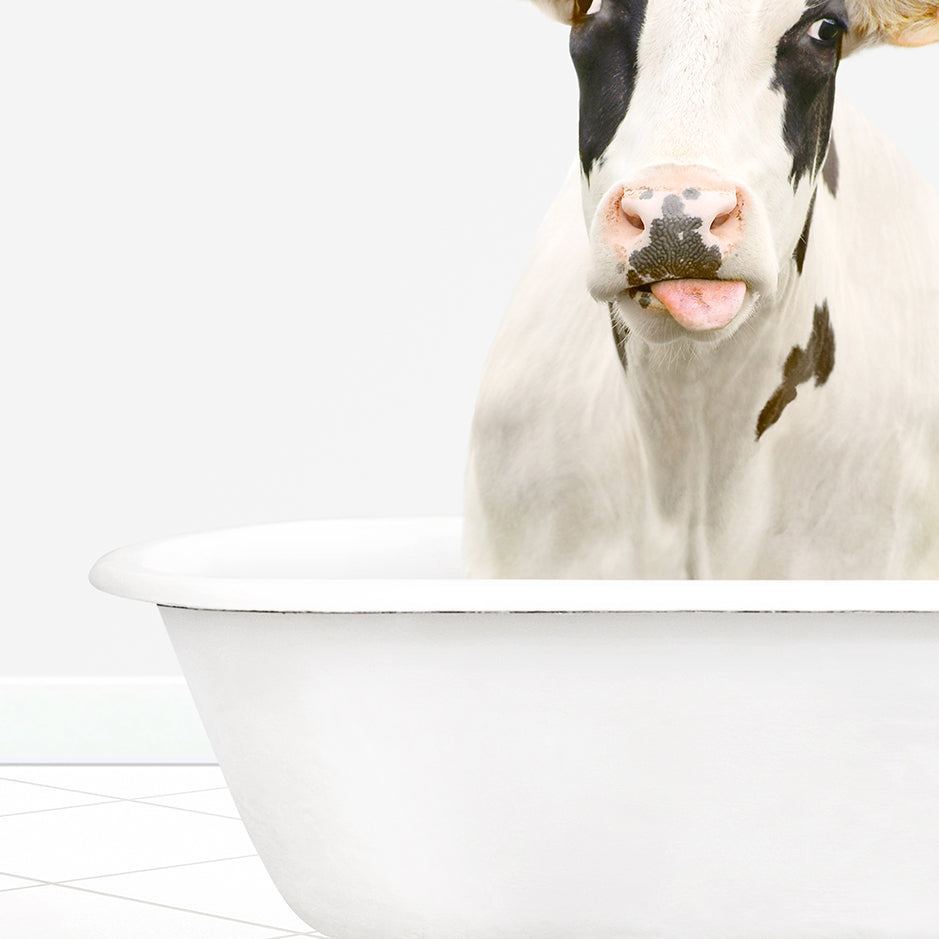 a cow sticking its tongue out in a bathtub