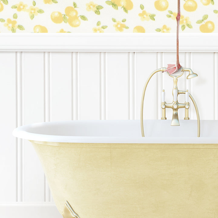 a bathroom with a yellow bathtub and yellow wallpaper