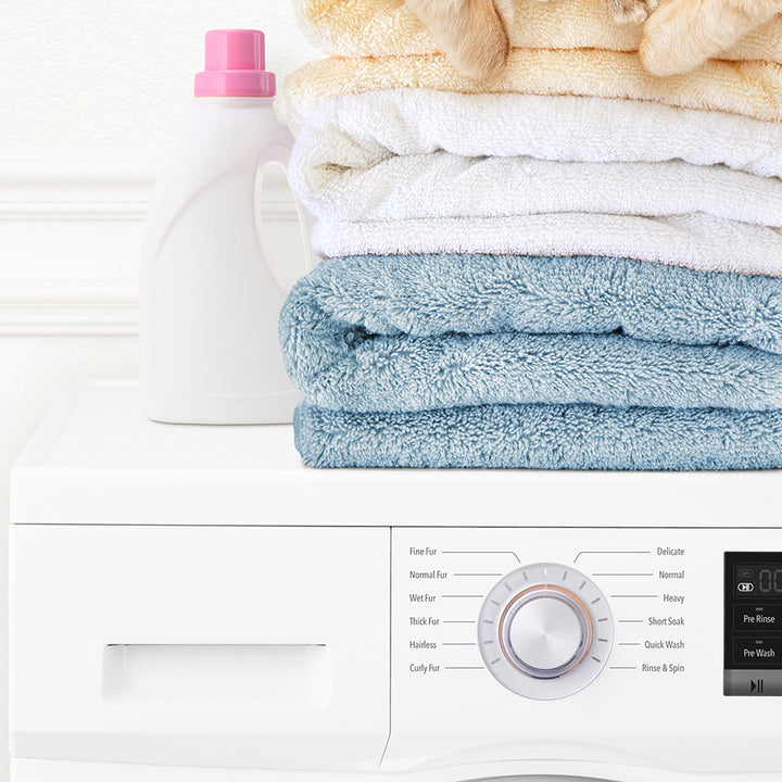 Pudgy Bunny on Folded Towels on Washing Machine - Simple White Wall